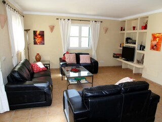 large living room, 2 sofas, 2 armchairs, sat-tv, aircon