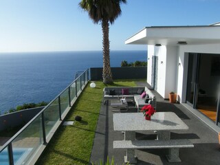 Terrace with dining table and outdoor lounge