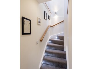 Stairs leading up to the kitchen and living area