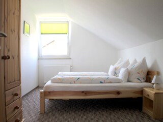 Bedroom with wardrobe in the attic