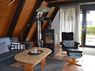 Gemütliches Wohnzimmer mit Kaminofen und Relaxsessel