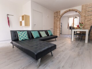 Bright living room with a comfortable sofa and view tow