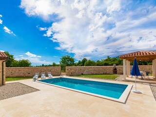 Private garden with a pool and loungers