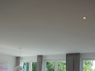 Dank der großen Fenstertüren verschmelzen die Küche mit Kochinsel und der angrenzende Essplatz mi...