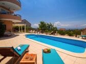 Relaxing sun deck area with 8 sun chairs.