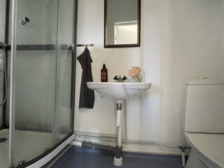 Das Badezimmer mit Dusche, WC und Waschbecken