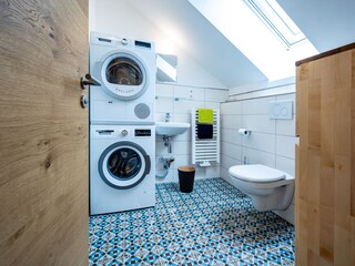 Guest bathroom with washing machine and dryer