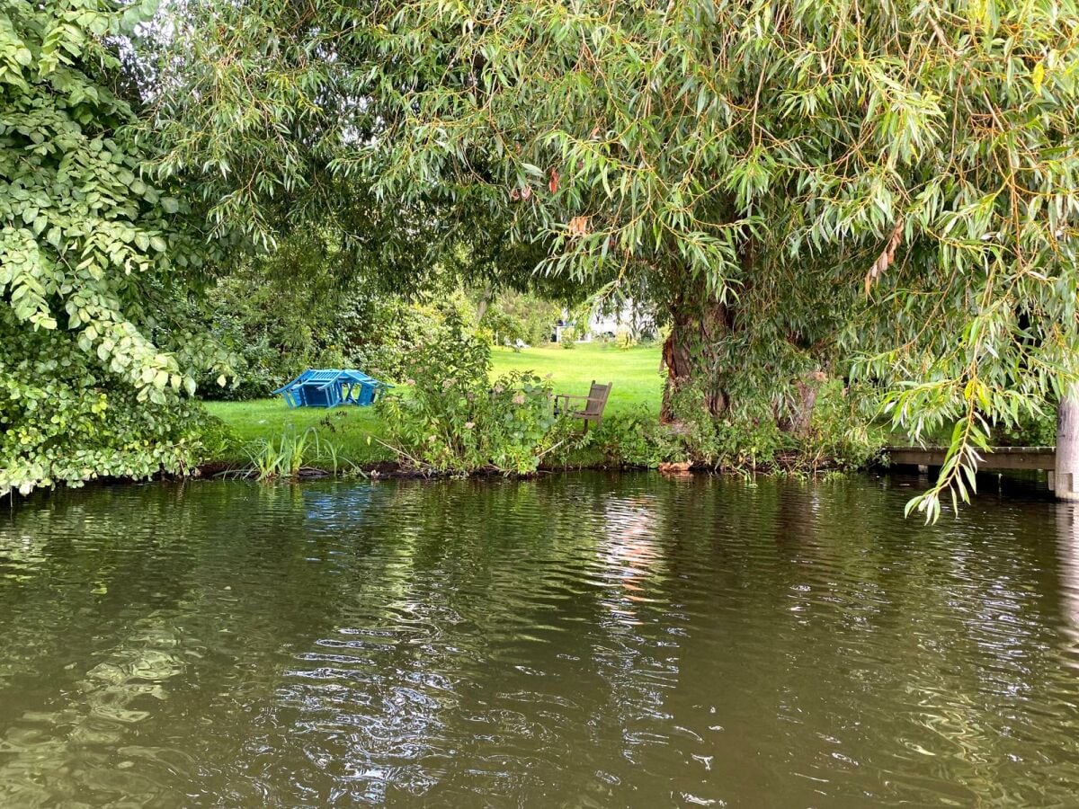 View from a boat to the garden of our WAKENITZ-Villa