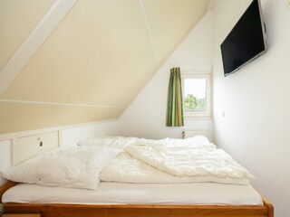 Das zweite Schlafzimmer mit Doppelbett und 43"-TV