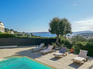 Pool area with teak sunbeds