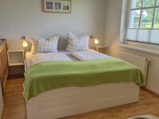 Schlafzimmer mit Kinderbett und Außenrollos