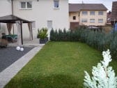 Garten hinter dem Haus mit Terrasse und Grillplatz