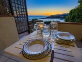 Waterfront veranda in front of sunset