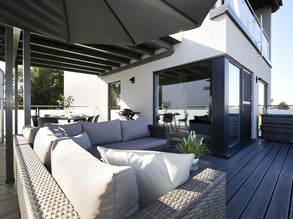 Large terrace with lounge furniture and dining table