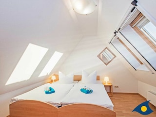 1. Schlafzimmer mit einem Doppelbett und einem Rollbett