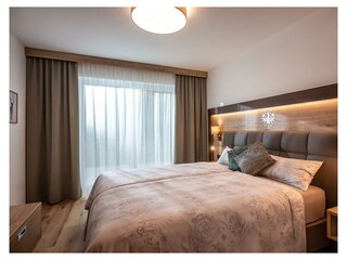 Söll_APARTdeluxe_Schlafzimmer_Ferienwohnung_Wilder