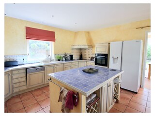 Well equipped kitchen with doors to side terrace