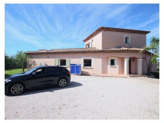 Frontside of the villa with entrance and parking places