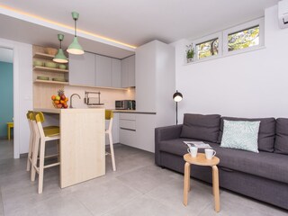 Kitchen and living room are one open space.