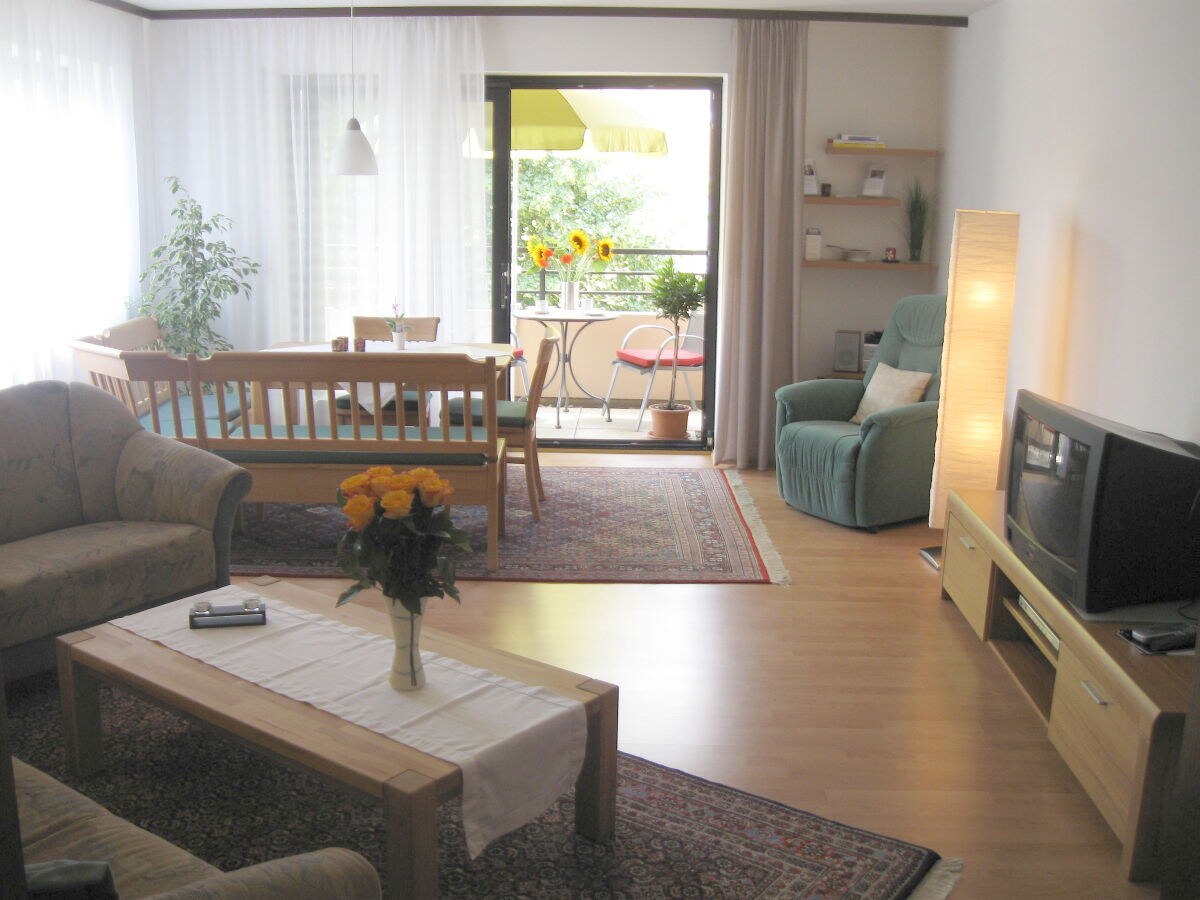 Large living room with dining area and balcony