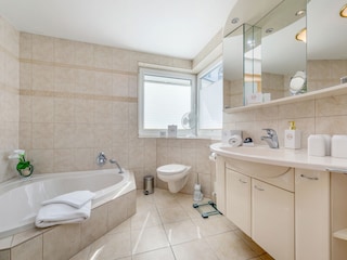Das Bad mit Badewanne, WC ...