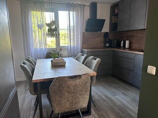 Modern new kitchen, comfortable chairs and a table