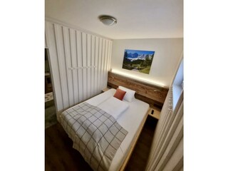 small bedroom with lights on