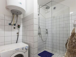 Downstairs shower room with washing machine.