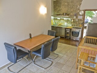 Upstairs kitchen,  cot.