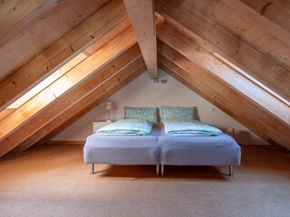 Two separate box spring beds in the loft space