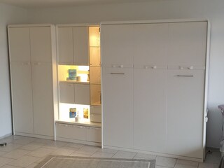 wardrobe with bed in living room