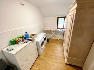 Utility room with washing machine, dryer, and iron
