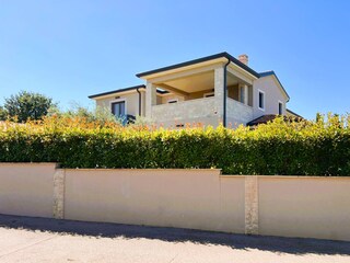 Komplett umzäunt mit hoher Mauer und Hecke