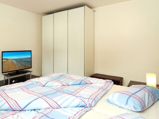 Schlafzimmer mit Doppelbett und Kleiderschrank