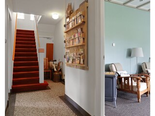 Hall with staircase and a peek into to living room