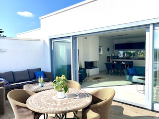 Terrasse mit Lounge, Esstisch und Sonnenschutz