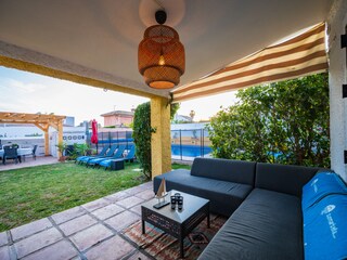 Terrace with sitting and dining area, pool sun loungers