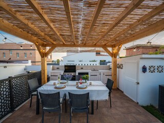 Outdoor area with gas BBQ and dining table for 8