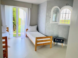 Bedroom 4 with doors to the garden and pool