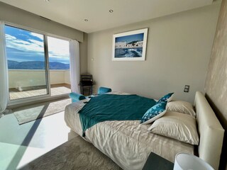 Bedroom 2 with doors to a private terrace