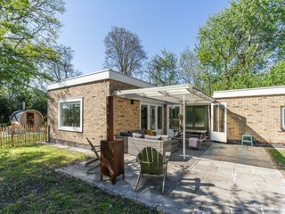 Die überdachte Terrasse mit Gartenmöbel und Außenkamin
