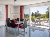 Large dining table overlooking the terrace and the lake