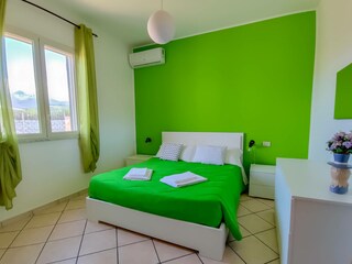 Bedroom with double bed and air conditioner