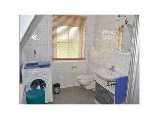 Badezimmer mit Dusche und Waschmaschine