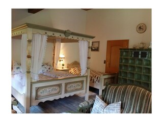 Four Post Bed with Single Bed in the Family Room