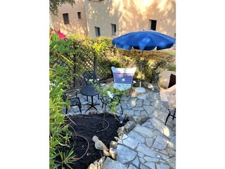 Small and shaded terrace with summer garden