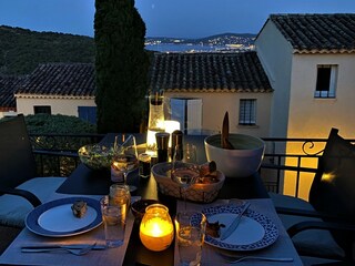 Terrace at night with view over the bay