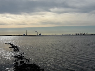 Die Flut kommt. Im Hintergrund der Jade Weser Port