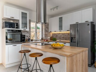 Kitchen with a pool view, and a sea view.