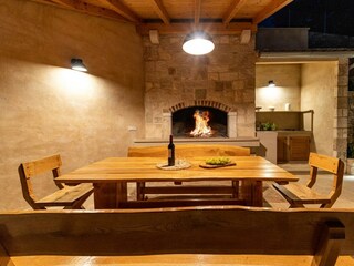 A summer kitchen with a traditional barbecue.